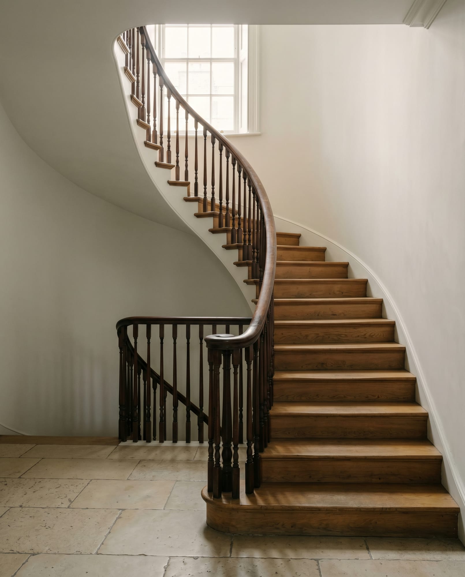 The principal staircase — original 1828 Cubitt joinery, repaired and conserved.