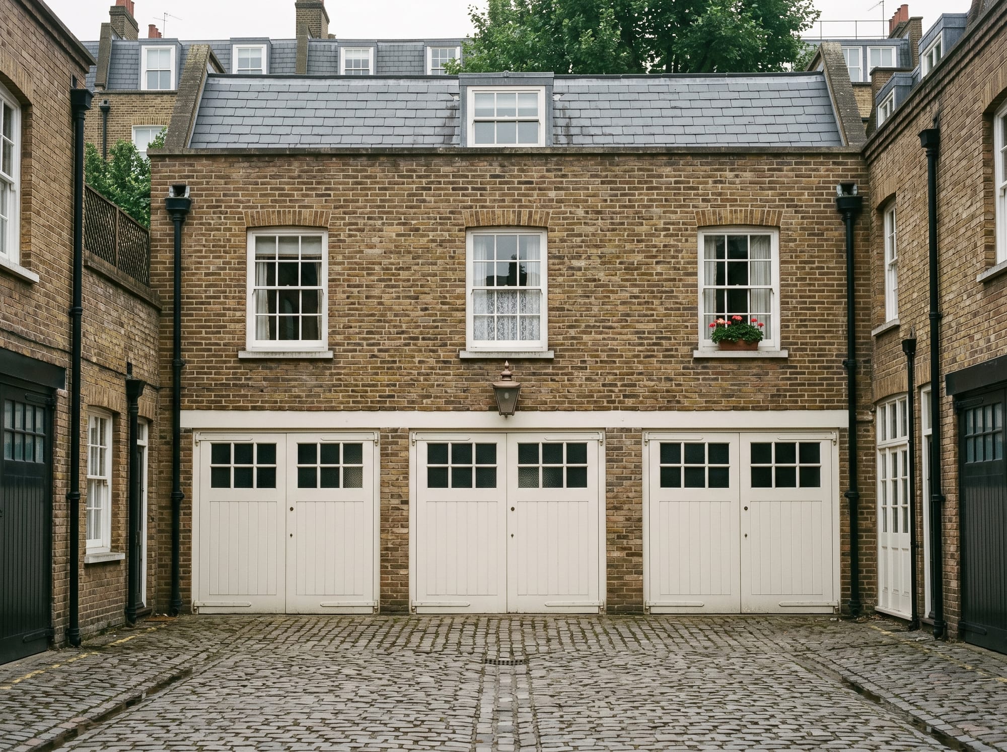 The mews cottage at the rear of the property — original carriage-house and stable, separate vehicular access from the mews row.